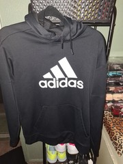 black Adidas Essentials Big Logo Hoodie featuring a prominent white Performance