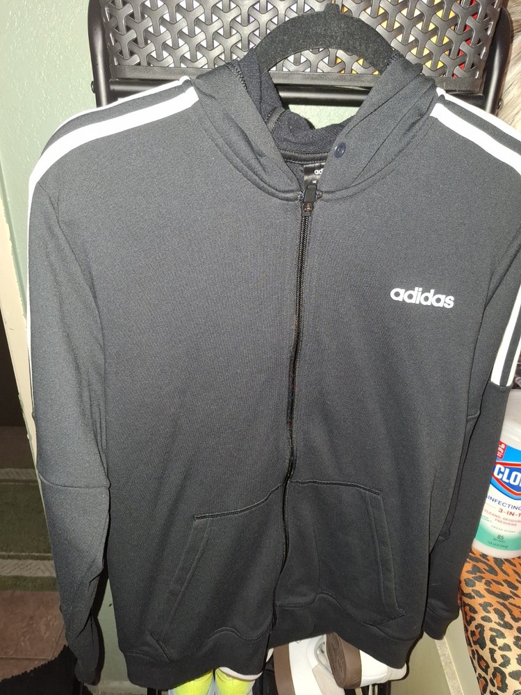 This is an Adidas Essentials Fleece 3-Stripes Full-Zip Hoodie in black with…